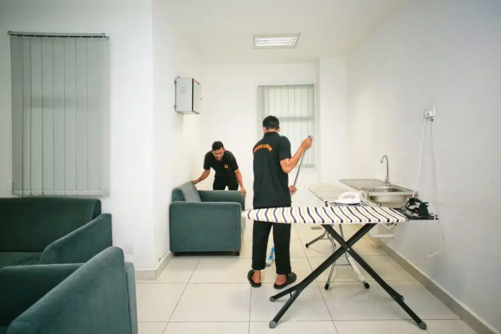 Two professional house cleaners cleaning a home